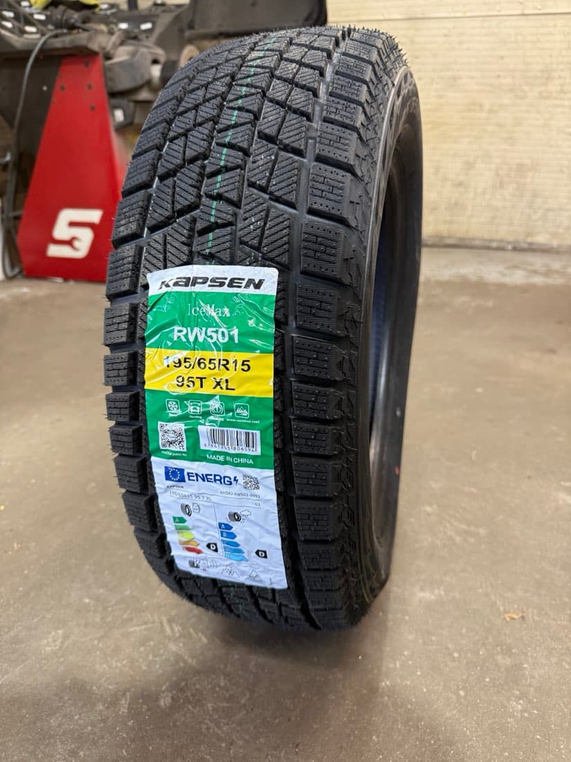 A new Kapsen IceMax RW501 winter tire in 195/65R15; its EU label shows the snowflake and ice symbols